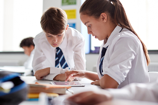 ofsted-2025-secondary-toolkit-resources two secondary school children in school looking down at school books - Launchpad to Ofsted New Inspection Framework